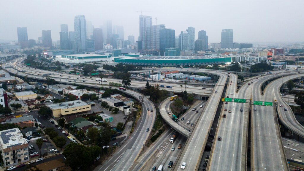 An aerial view shows downtown Los Angeles on April 30. U.S. miles driven decreased remarkably quickly in March, and driving slowly started to resume again — while remaining well below typical levels. An aerial view shows downtown Los Angeles on April 30. U.S. miles driven decreased remarkably quickly in March, and driving slowly started to resume again — while remaining well below typical levels. (Robyn Beck/AFP via Getty Images)