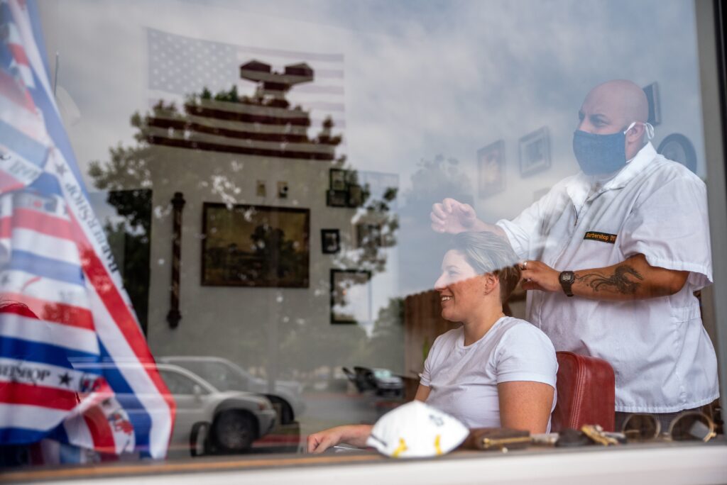 A woman gets a haircut on Friday in Round Rock, Texas, as the state slowly reopens from its pandemic shutdown. Woman receives haircut
