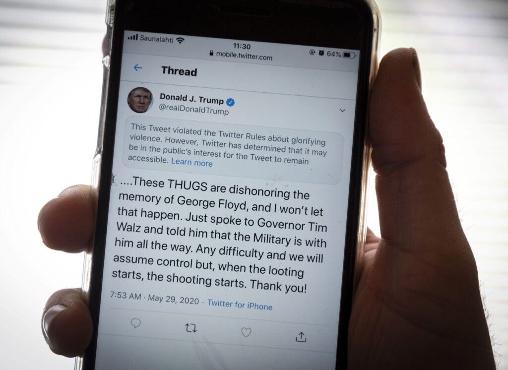 President Trump’s Twitter page is displayed on a mobile phone. The social media company flagged one of his tweets about Minneapolis as “glorifying violence” and hid it from public view unless a user clicks on it. President Trump's Twitter page is displayed on a mobile phone. The social media company flagged one of his tweets about Minneapolis as