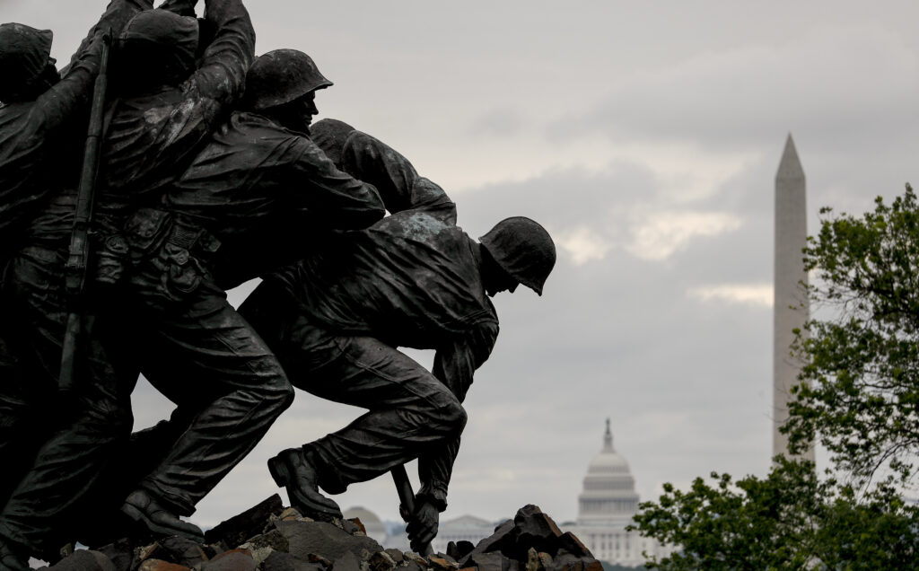 The Washington Monument and the dome of the U.S. Capitol Building are visible behind the U.S. Marine Corps War Memorial in Arlington, Va., on Memorial Day. Washington Monument