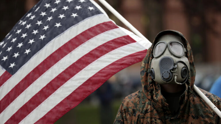 A protester attends a demonstration over Michigan's coronavirus restrictions on Thursday at the state Capitol in Lansing. (Paul Sancya/AP Photo)