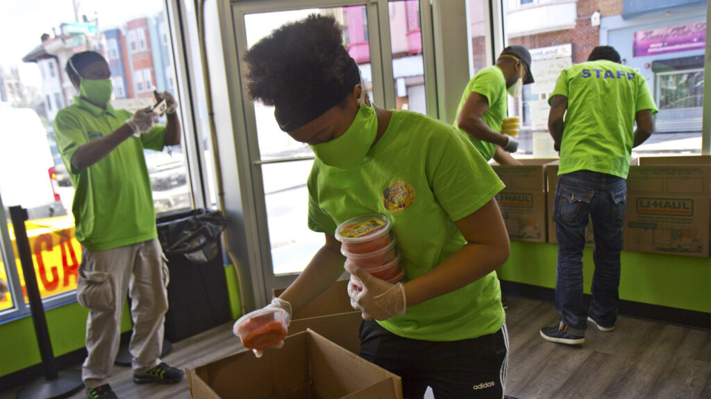 Kierah Rigney, 14, packs strawberry water to to go essential workers at the University of Pennsylvania’s hospital in Philadelphia. (Kimberly Paynter/WHYY)