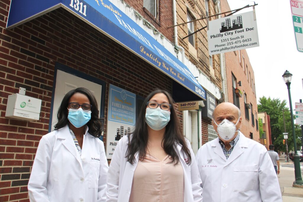 2020 05 29-e lee-patricia howie kim nguyen michael walinsky-philadelphia city foot doc-outside Philly City Foot Doc podiatrists (from left) Priscilla Howie, Kim Nguyen and Michael Walinsky outside their South Street offices. (Emma Lee/WHYY)