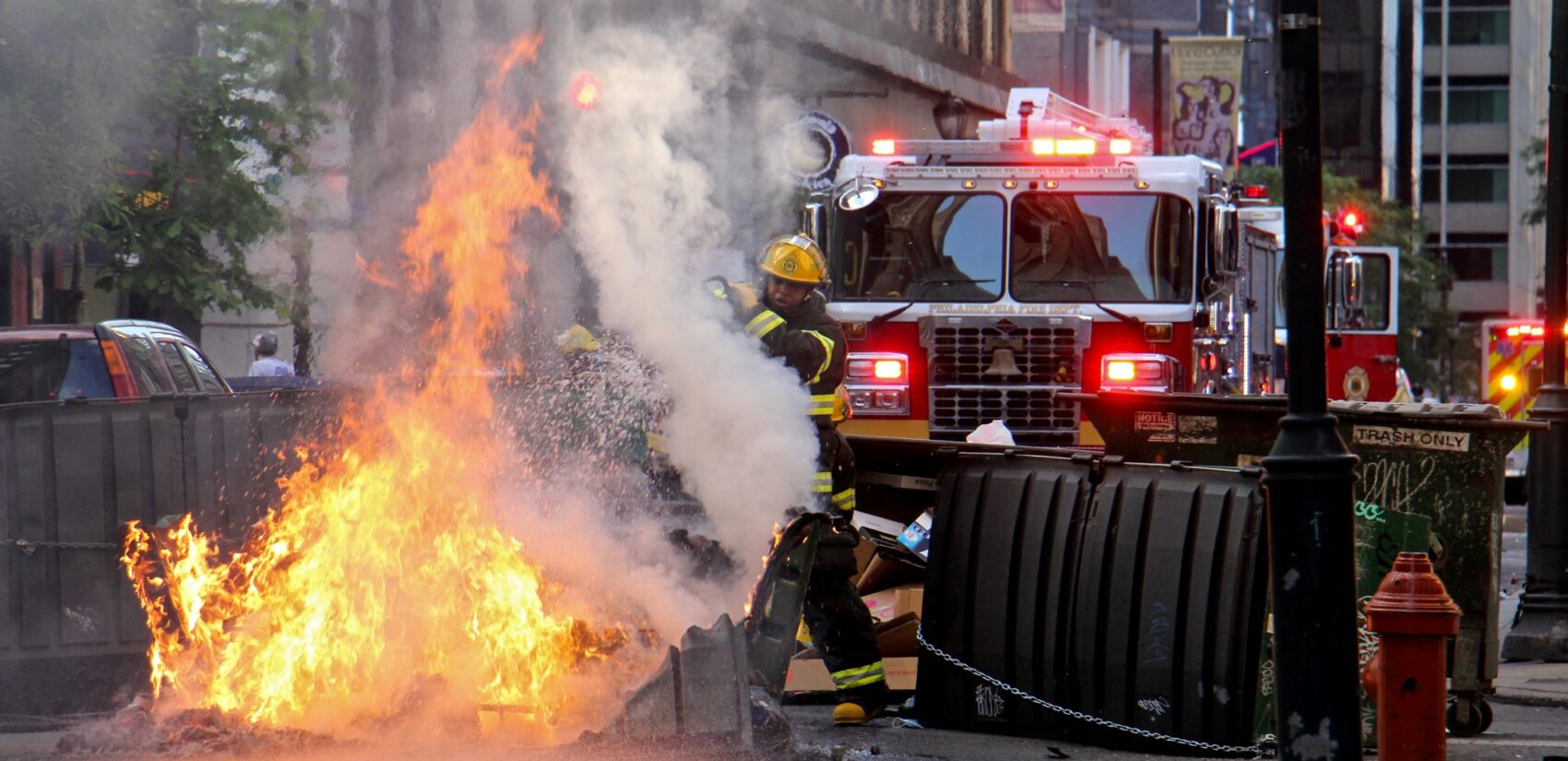 A Philadelphia firefighter puts out a dumpster fire