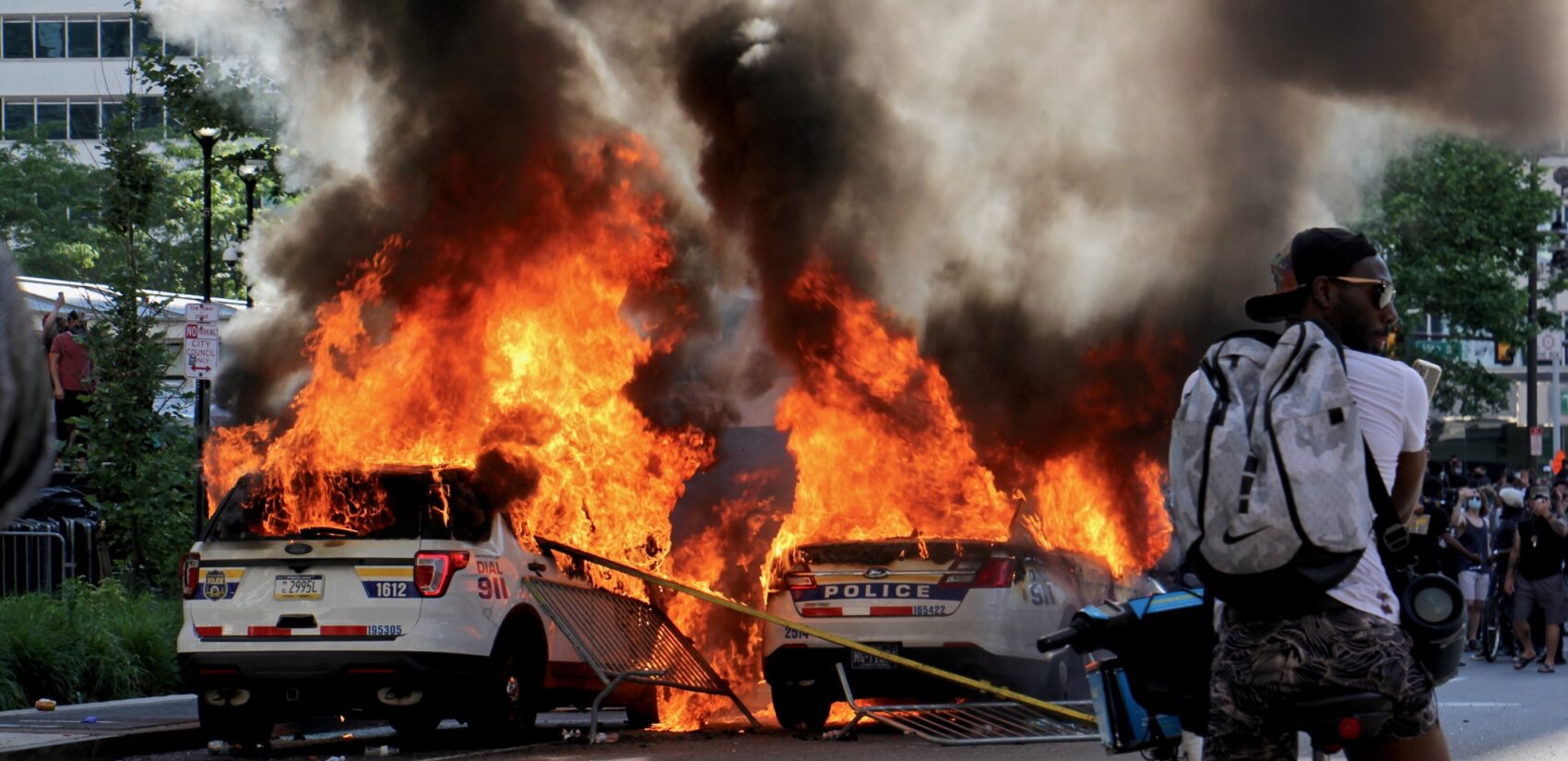 Police cars burn in front of City Hall