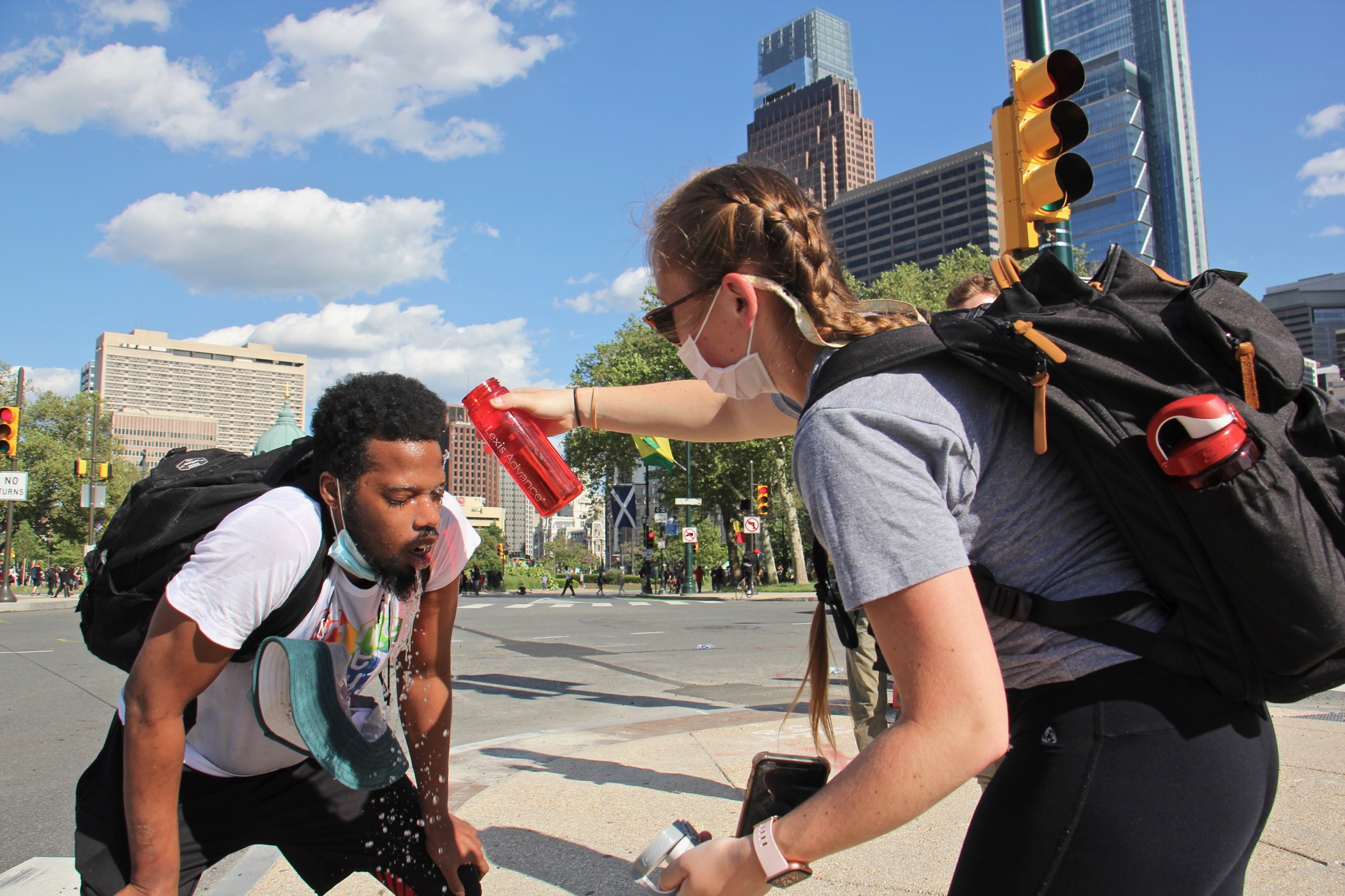 Protesters help each other after being tear-gassed