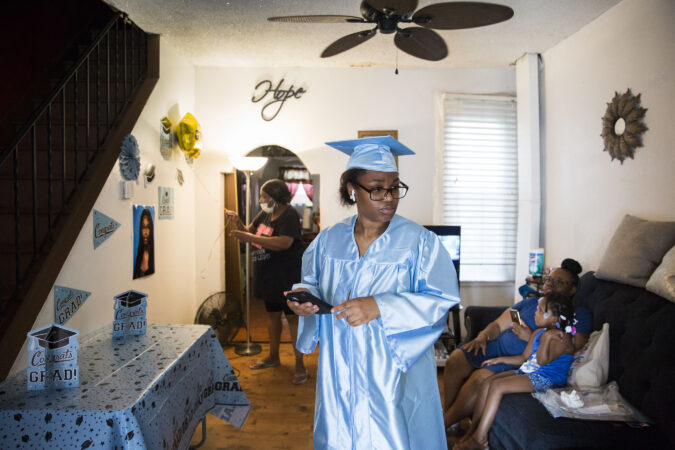 Aliah prepares for Paul Robeson High School's virtual graduation ceremony at her father's house in Grays Ferry on June 10, 2020. (Rachel Wisniewski for Keystone Crossroads)