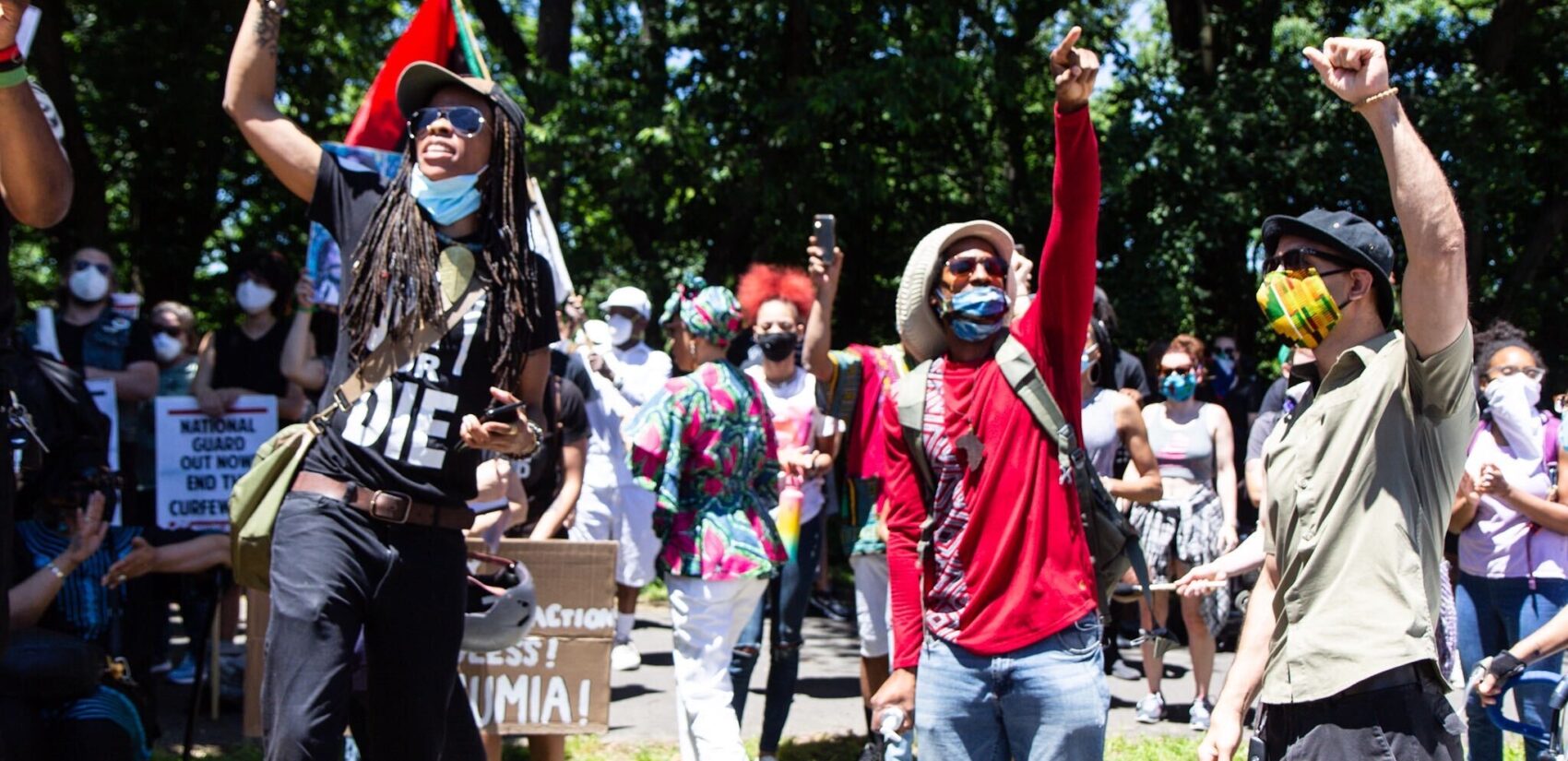 Mike Africa Jr. raises a fist with other protesters