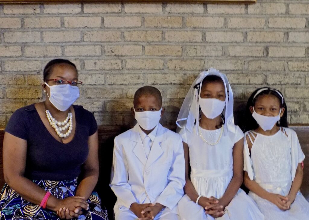 2020 06 14-x conde-philadelphia-pandemic return to church family Jennifer Ballard (left) accompanies her children (from lert) Allan and Allyson Ballard, and their friend Joselyn Turner, as they get ready for their First Holy Communion. (Ximena Conde/WHYY News)
