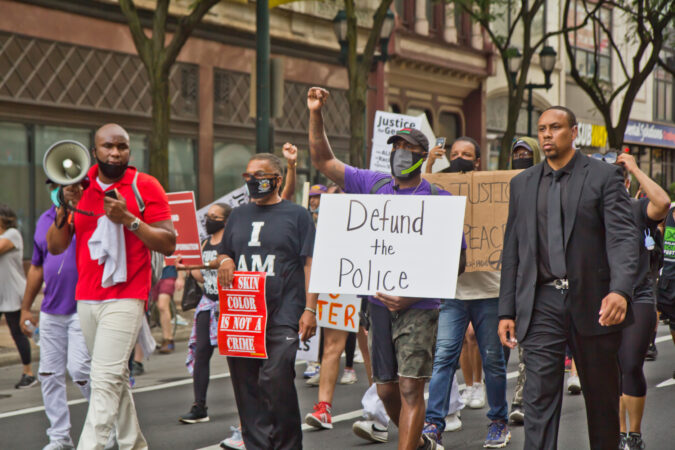 Former Philadelphia Eagles Safety Malcolm Jenkins raised a fist and marched with protesters in Philadelphia. (Kimberly Paynter/WHYY)