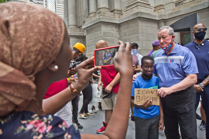 Philadelphia Mayor Jim Kenney posed for a picture with Ibra, 8, Saturday, as Black fraternities and sororities gathered at City Hall to call for social reform in Philadelphia. (Kimberly Paynter/WHYY)