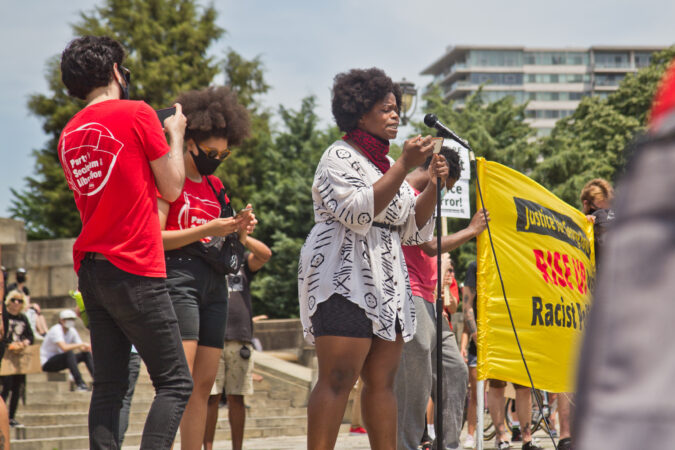 A’Brianna Morgan, lead mass liberation organizer for Reclaim Philadelphia, called for fair housing, child care, health care, education and housing for all at Saturday’s protest at the Philadelphia Art Museum. (Kimberly Paynter/WHYY)