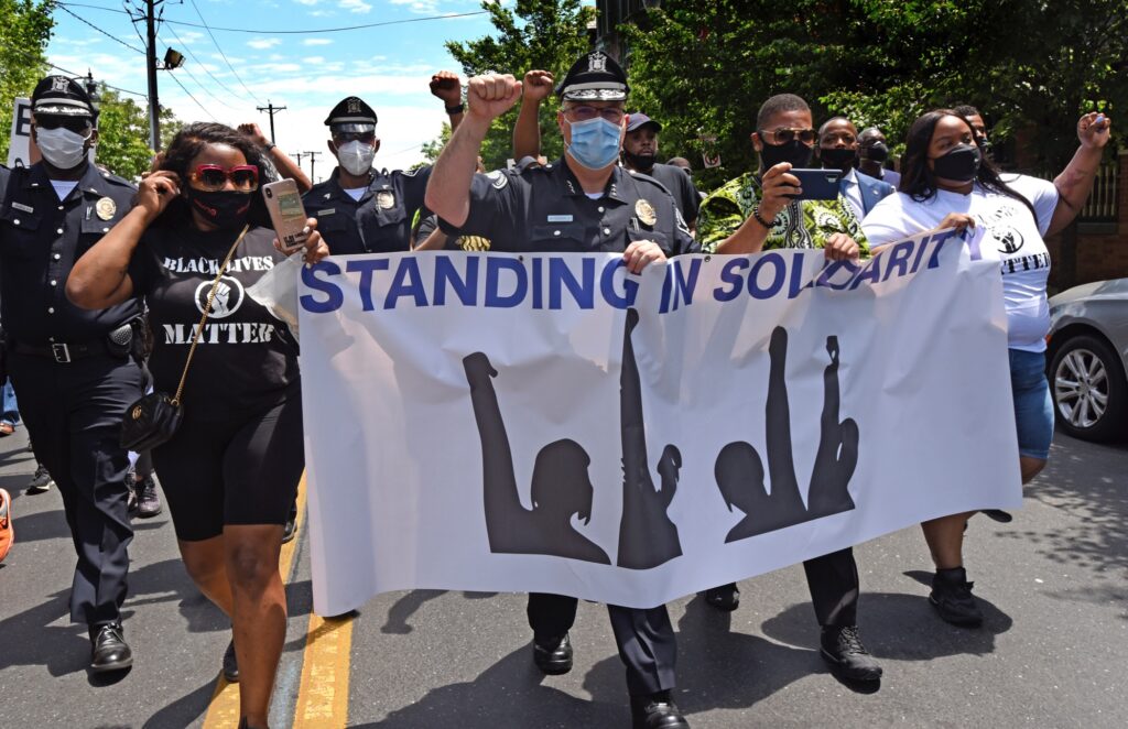 APTOPIX America Protests Police Praise Camden County Metro Police Chief Joe Wysocki raises a fist while marching with Camden residents and activists on May 30, 2020 to protest the killing of George Floyd in Minneapolis. (Photo by April Saul via AP)