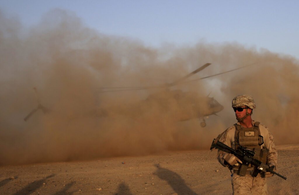 In this Aug. 27, 2017 file photo, a U.S. Marine takes part during a training session for Afghan army commandos in Shorab military camp in Helmand province, Afghanistan. (AP Photo/Massoud Hossaini, File)