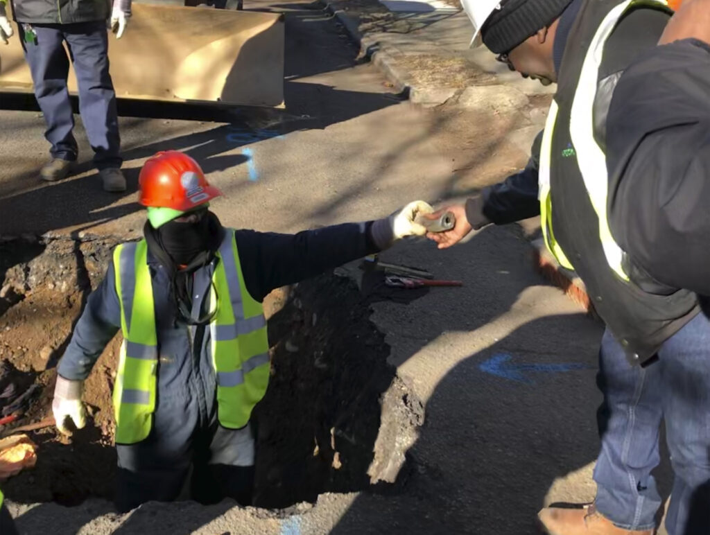 Lead Water Pipes New Jersey A worker hands a piece of lead pipe to a colleague as they work to remove water service lines Thursday, Jan. 9, 2020 in Trenton, N.J. The city announced it is replacing 37,000 lead pipes over five years as part of an an effort to remove the potentially harmful pipes. (AP Photo/Mike Catalini)