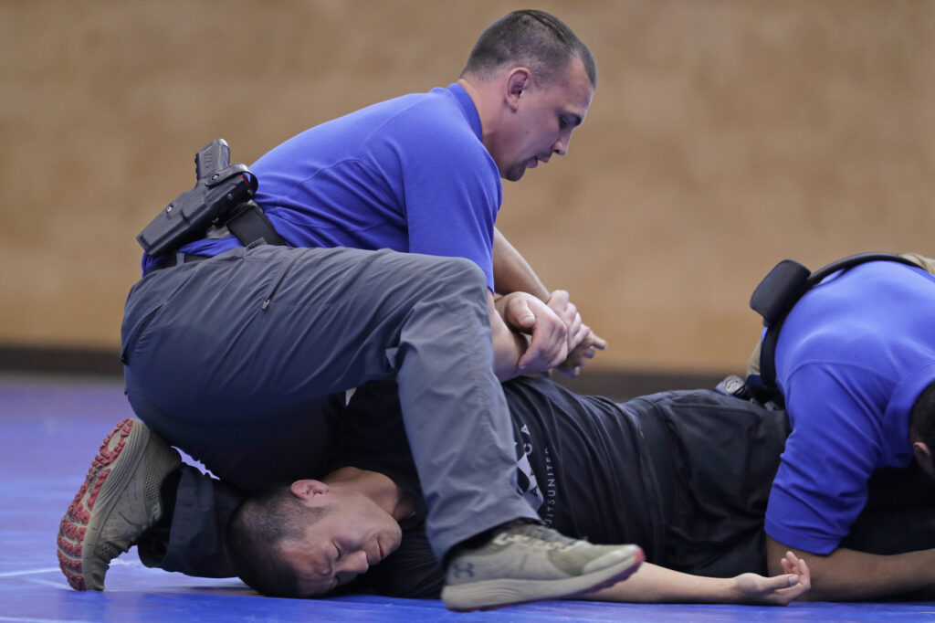America Protests Police Training In this June 4, 2020, photo, Brandon Wilson, upper left, an instructor at the Washington state Criminal Justice Training Commission facility in Burien, Wash., restrains fellow instructor Ben Jia, lower left, during a demonstration for The Associated Press on takedown and restraint techniques taught to law enforcement officers as part of the more than 700 hours of training police and other officers are required to to through in the state. Police training has been under scrutiny again since the death of George Floyd, a black man who died after being restrained by Minneapolis police officers. (AP Photo/Ted S. Warren)