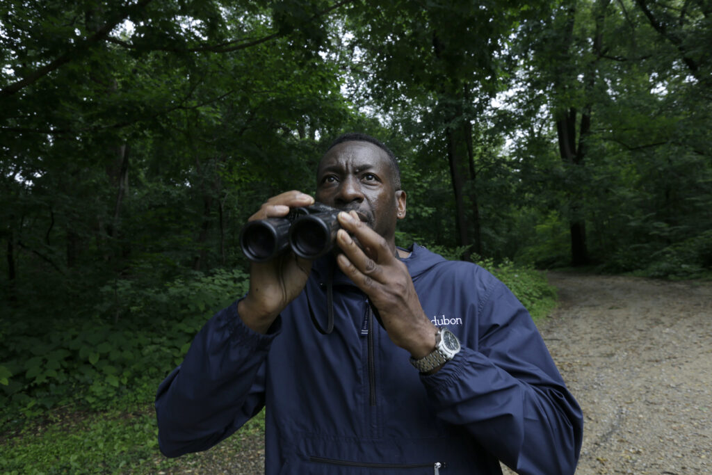 Keith Russell Keith Russell, program manager of urban conservation at Audubon Pennsylvania, lowers his binoculars while conducting a breeding bird census, at Wissahickon Valley Park Friday, June 5, 2020 in Philadelphia. (AP Photo/Jacqueline Larma)