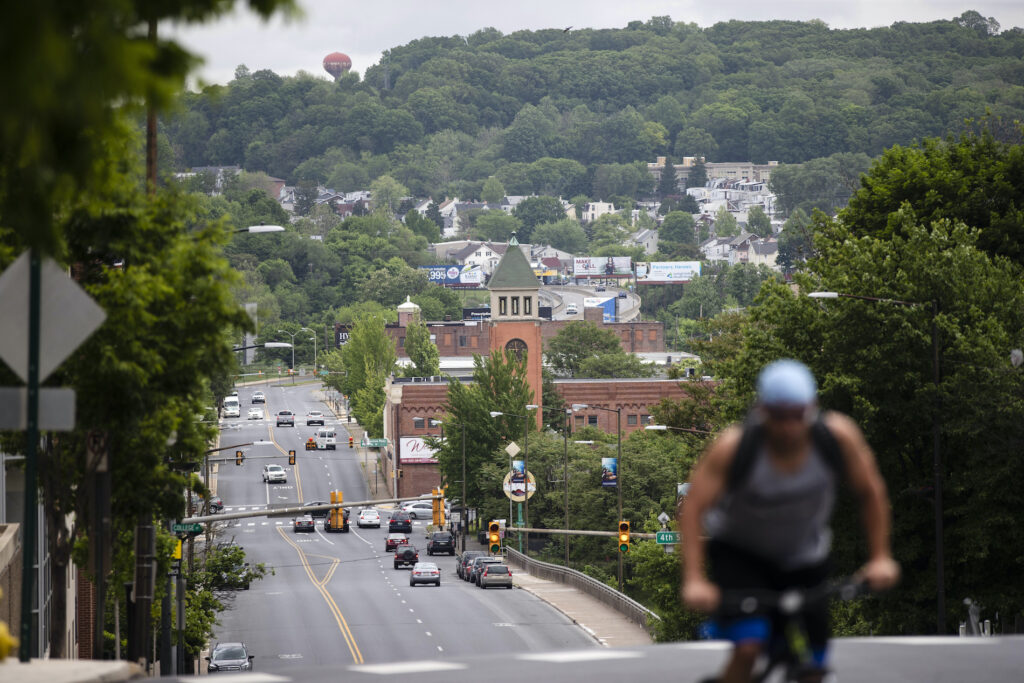 Virus Outbreak Relief Left Out File photo: A cyclist peddles up a hill in Allentown, Pa., on Friday, May 29, 2020. (AP Photo/Matt Rourke)