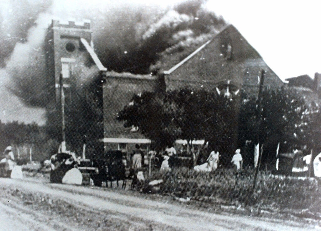 America Protests Trump Juneteenth FILE - In this 1921 file image provided by the Greenwood Cultural Center via Tulsa World, Mt. Zion Baptist Church burns after being torched by white mobs during the 1921 Tulsa massacre. Black community and political leaders called on President Donald Trump to at least change the Juneteenth date for a rally kicking off his return to public campaigning, saying Thursday, June 11, 2020. From Sen. Kamala Harris of California to Tulsa civic officials, black leaders said it was offensive for Trump to pick that date — June 19 — and that place — Tulsa, an Oklahoma city that in 1921 was the site of a fiery and orchestrated white-on-black killing spree. (Greenwood Cultural Center via Tulsa World via AP)