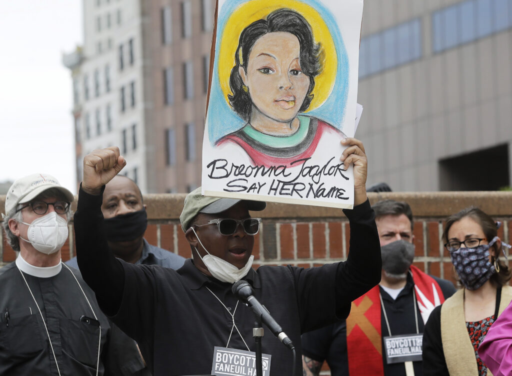 America Protests Kentucky In this June 9, 2020, file photo, Kevin Peterson, center, founder and executive director of the New Democracy Coalition, displays a placard showing Breonna Taylor as he addresses a rally in Boston. (AP Photo/Steven Senne, File)