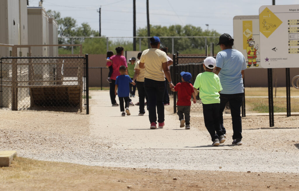 Virus Outbreak Immigration Detention In this Aug. 23, 2019 file photo, immigrants seeking asylum hold hands as they leave a cafeteria at the ICE South Texas Family Residential Center in Dilley, Texas. (AP Photo/Eric Gay, File)