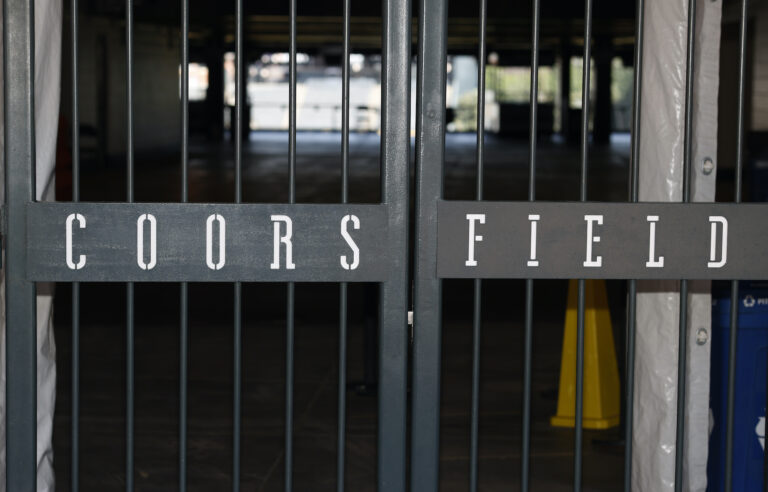 The main gate of Coors Field, home of the Major League Baseball team the Colorado Rockies, is locked early Tuesday, June 23, 2020, in Denver. (AP Photo/David Zalubowski)