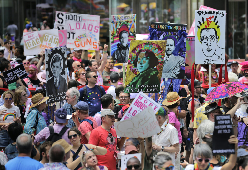 LGBTQ Pride 50 Years In this June 30, 2019, file photo, marchers carry signs with historical LGBTQ figures during the Queer Liberation March in New York. (AP Photo/Seth Wenig, File)