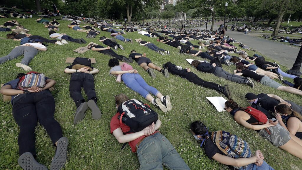 Demonstrators lie face down depicting George Floyd during his detention by police