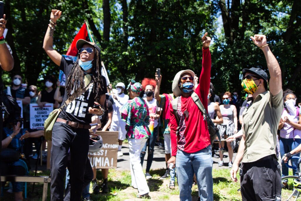 EaaDFHNWoAISoSc Mike Africa, Jr. (center) and demonstrators protest in West Philadelphia, in the neighborhood where police dropped a bomb on the MOVE organization in 1985, killing 11 Black residents. (Kimberly Paynter/WHYY)