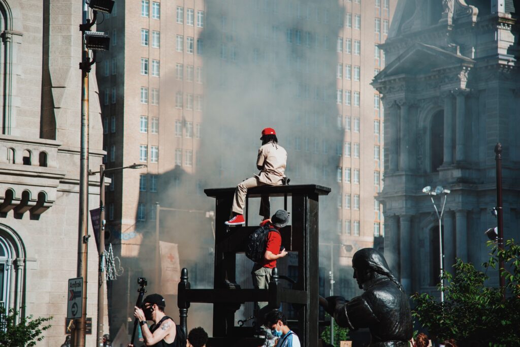 Processed with VSCO with c8 preset Protesters watch smoke from police vehicles rise. (Phobymo)