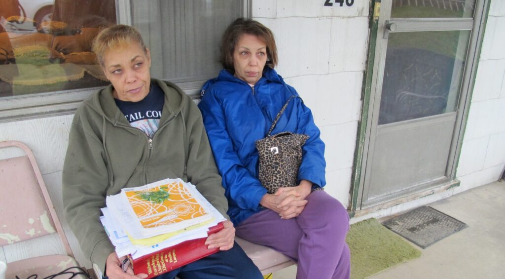 IMG_0975-e1593116148354-1920×1060 Jeanie Moten with her sister on their mother's porch in Rea, Pa. She holds a stack of medical records. The Motens say they received no help from DOH regarding their fracking health complaints. A case file released by the DOH through a Right-To-Know request confirmed that. (Susan Phillips / StateImpactPA)