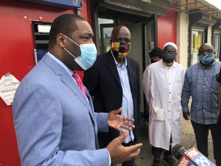 Councilmember Kenyatta Johnson spoke with workers and community members at Woodland Village Plaza in Southwest Philadelphia on Tuesday morning. (Meir Rinde for WHYY)