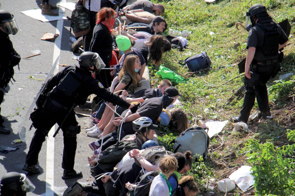 Image from iOS (42) Police arrest dozens of protesters on Route 676 near 21st Street after they blocked traffic.