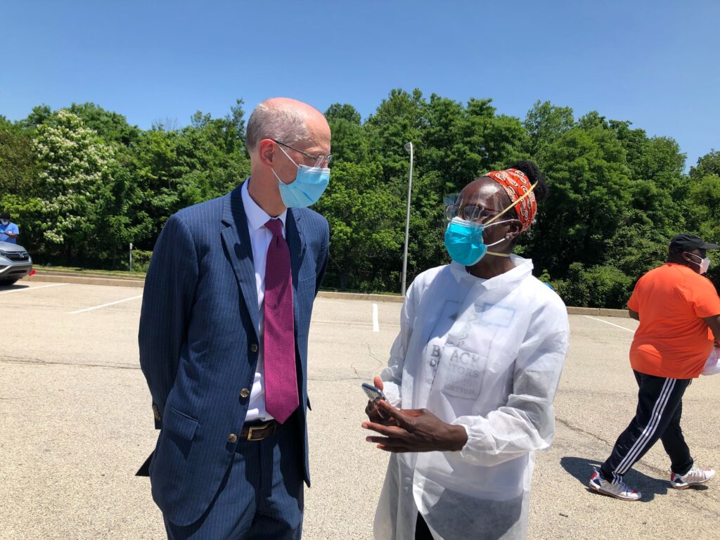 Image from iOS (49) Philadelphia Health Commissioner Thomas Farley speaks with Dr. Ala Stanford, head of the Black Doctors COVID-19 Consortium. (Nina Feldman/WHYY)