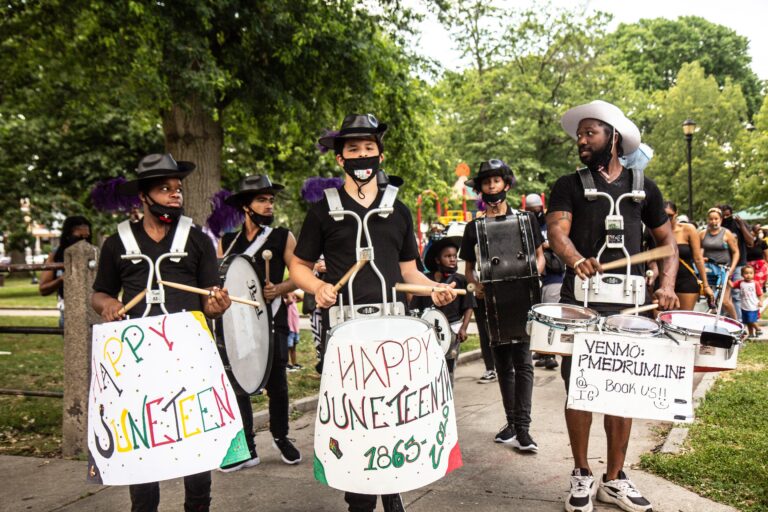 The Positive Movement Entertainment drill team leads a protest