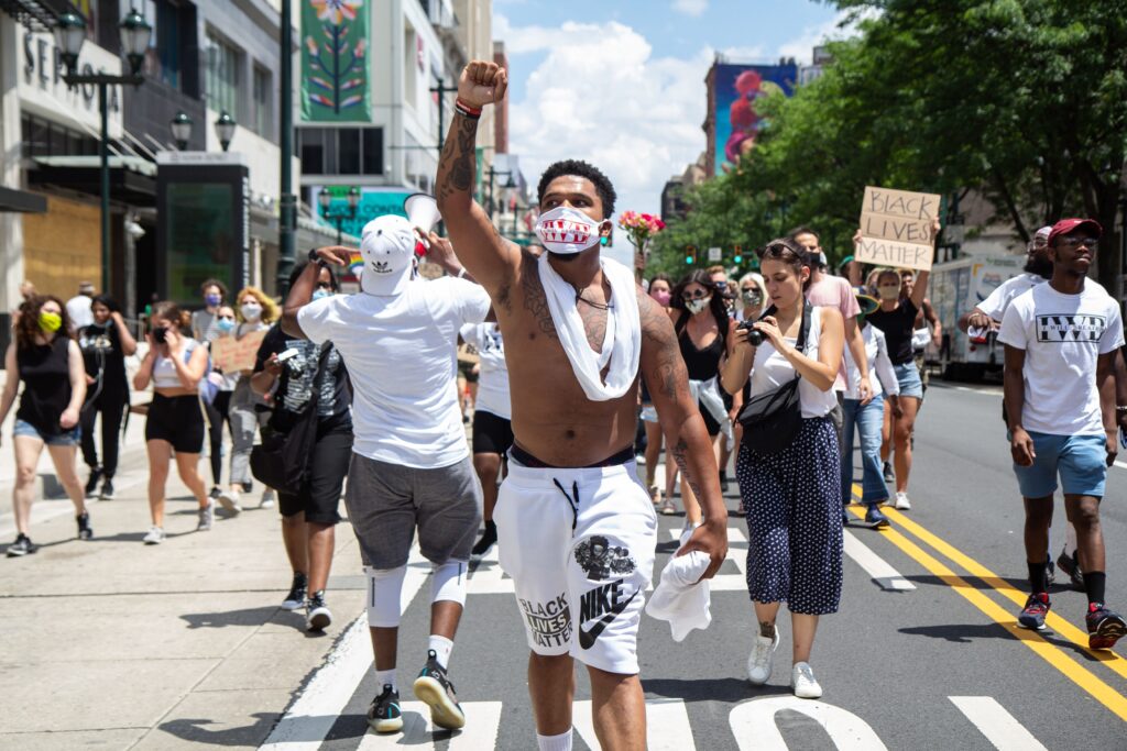 Image from iOS (87) Chris Bowman holds up a fist demanding justice for Black people in the U.S. during a Juneteenth march in Philadelphia. (Kimberly Paynter/WHYY)