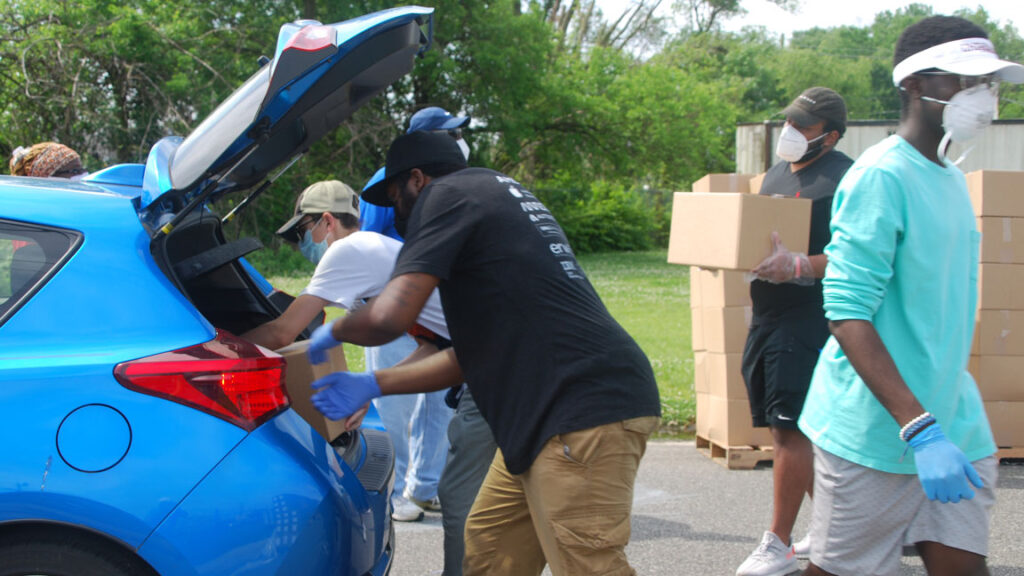 Volunteers-Food-Bank-of-South-Jersey-June-6-2020 Volunteers load food boxes into cars during a food distribution by the Food Bank of South Jersey in Riverside, Burlington County on June 6. (Jon Hurdle/NJ Spotlight)