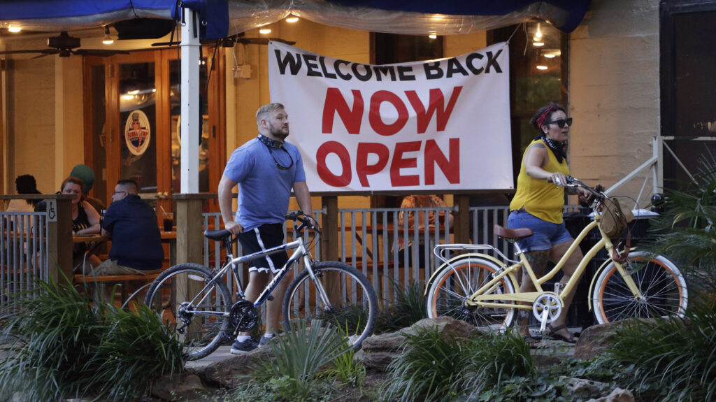 Visitors to the River Walk pass a restaurant that has reopened in San Antonio, Texas, on May 27. Texas continues to reopen in the wake of the COVID-19 pandemic.