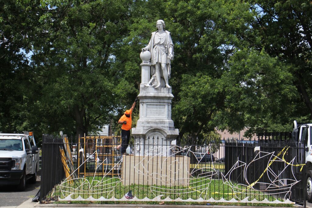 christopher_columbus_statue_protest_EL_061620 A worker measures the Christopher Columbus statue at Marconi Plaza