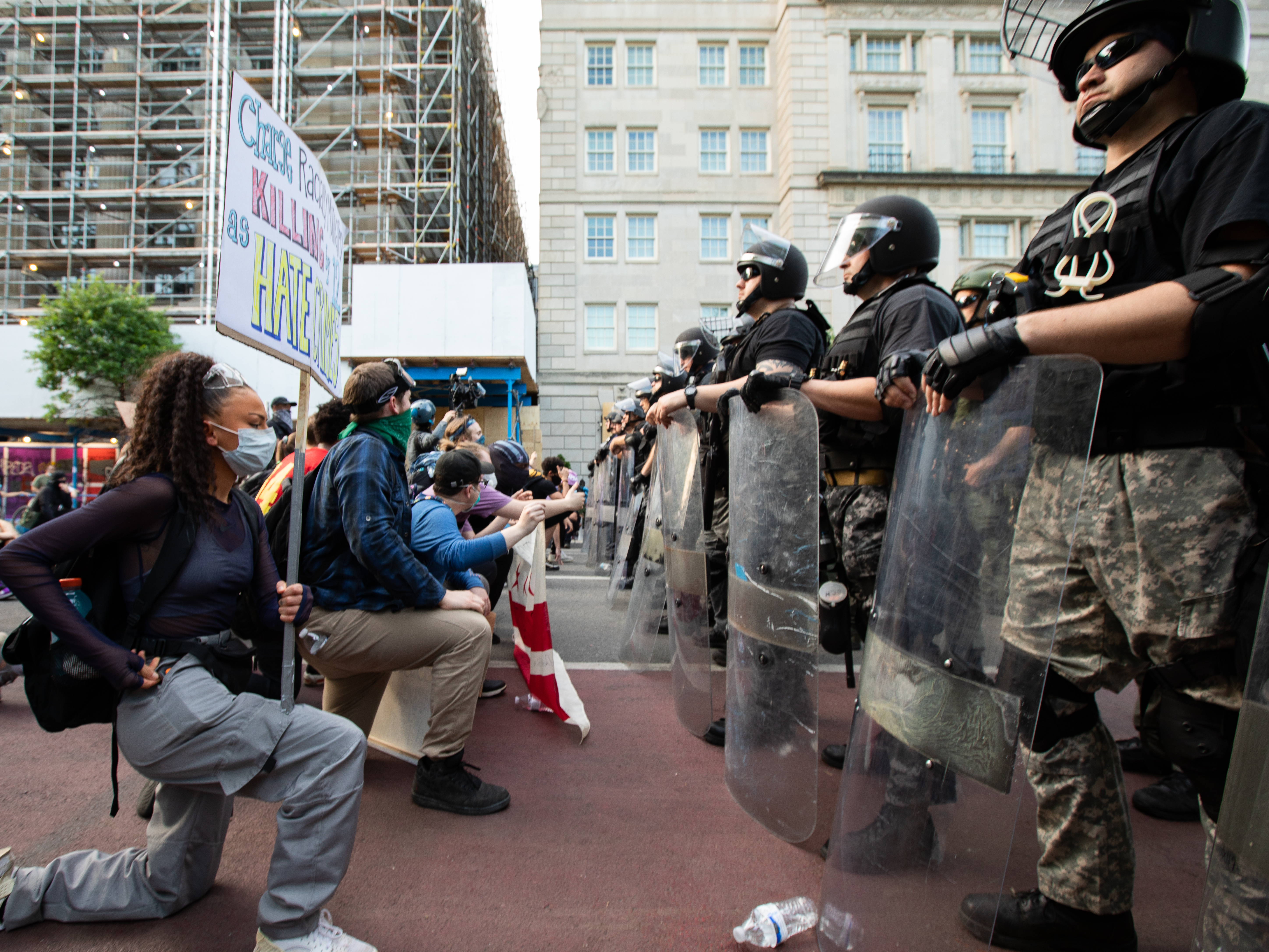 Demonstrators take a knee during a march outside the White House on the sixth consecutive day of protests.