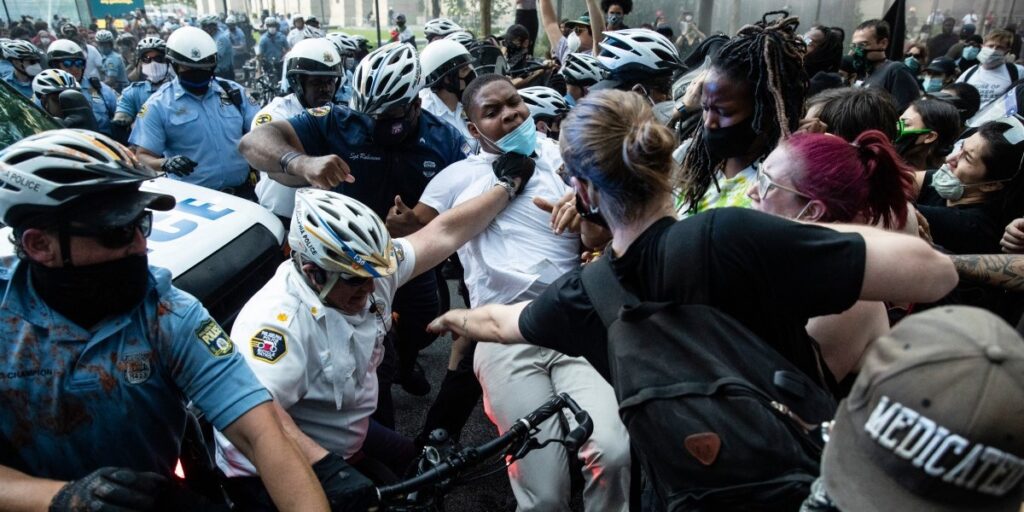 fb AP_20152131211906 (1) Police and protesters clash Saturday, May 30, 2020, in Philadelphia, during a demonstration over the death of George Floyd. Protests were held throughout the country over the death of Floyd, a black man who died after being restrained by Minneapolis police officers on May 25. (AP Photo/Matt Rourke)