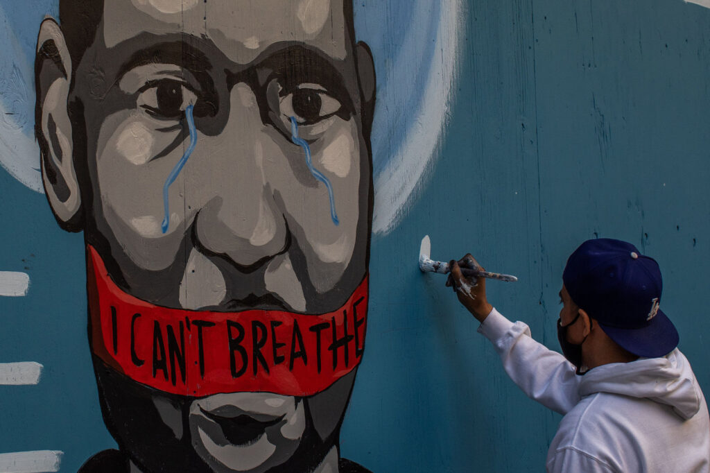The artist Celos paints a mural in downtown Los Angeles on May 30, 2020 in protest against the killing of George Floyd by police in Minneapolis. The artist Celos paints a mural in downtown Los Angeles on May 30, 2020 in protest against the killing of George Floyd by police in Minneapolis. (Apu Gomes/AFP via Getty Images)