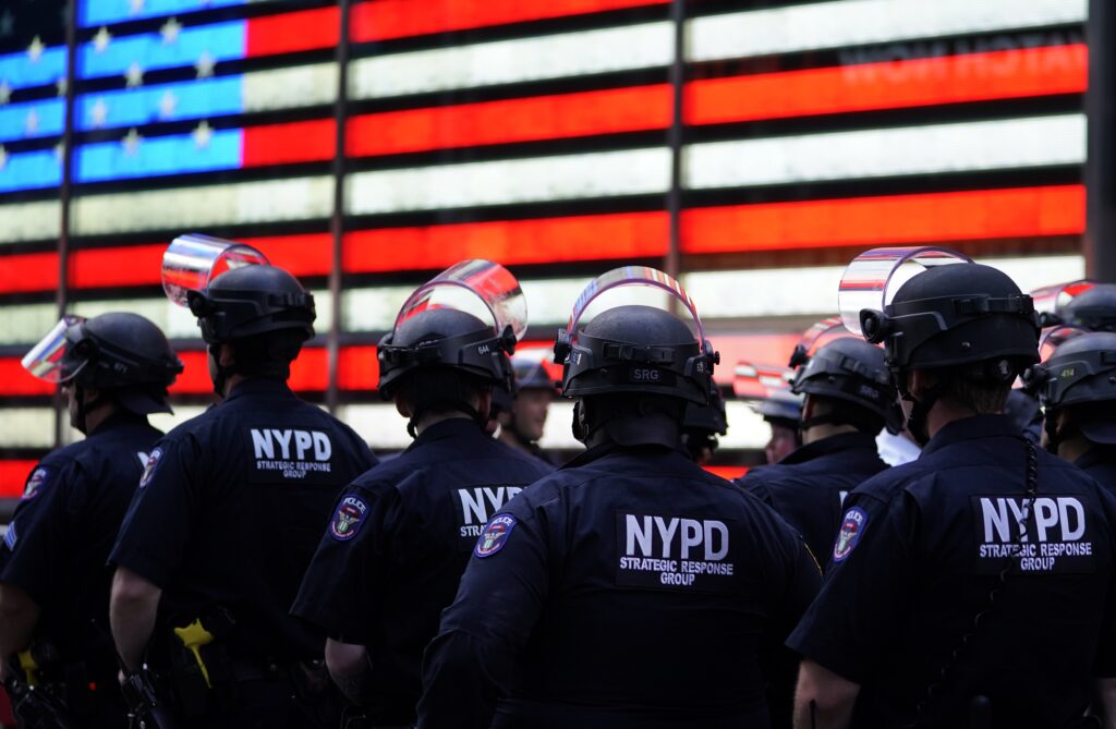 NYPD police officers watch demonstrators in Times Square on June 1, 2020, during a “Black Lives Matter” protest. NYPD police officers watch demonstrators in Times Square on June 1, 2020, during a