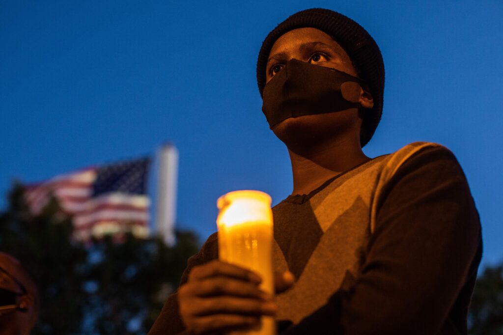 A man holds a candle during a vigil around a makeshift memorial at the tree where Robert Fuller was found dead hanging from a rope in Palmdale, Calif. Officials deemed Fuller’s death a suicide, but his family wants an independent investigation. A man holds a candle during a vigil around a makeshift memorial at the tree where Robert Fuller was found dead hanging from a rope in Palmdale, Calif. Officials deemed Fuller's death a suicide, but his family wants an independent investigation.