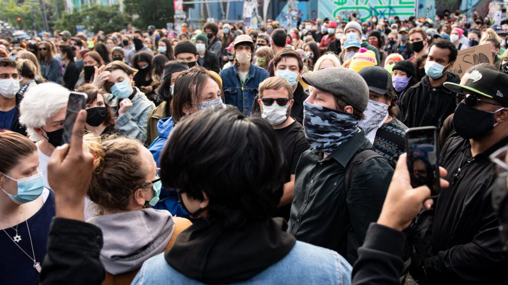 A man carrying a brick is confronted by protesters inside the Capitol Hill Organized Protest in Seattle on June 14. A man carrying a brick is confronted by protesters inside the Capitol Hill Organized Protest in Seattle on June 14.