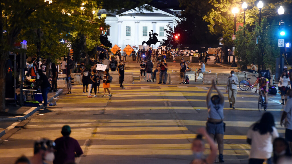 Protesters gather on Friday night at Black Lives Matter Plaza in front of the White House and the statue of former President Andrew Jackson, which is protected by a fence and concrete blocks. Protesters gather on Friday night at Black Lives Matter Plaza in front of the White House and the statue of former President Andrew Jackson, which is protected by a fence and concrete blocks.