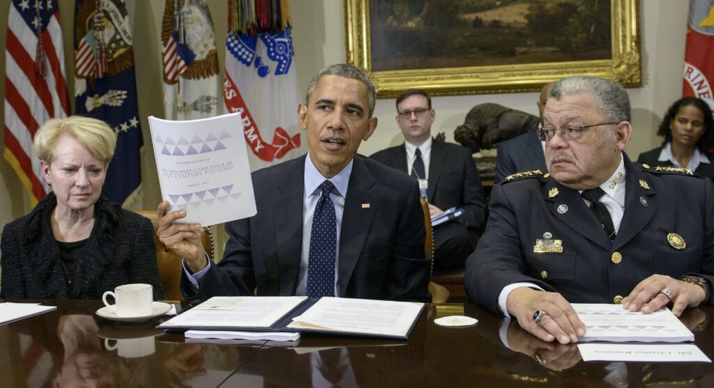 Laurie Robinson, left, professor of criminology at George Mason University, and Charles Ramsey, right, Philadelphia police commissioner, listen while President Obama discusses law enforcement recommendations from his Task Force on 21st Century Policing in March 2015. Laurie Robinson and Charles Ramsey listen while President Obama discusses law enforcement recommendations