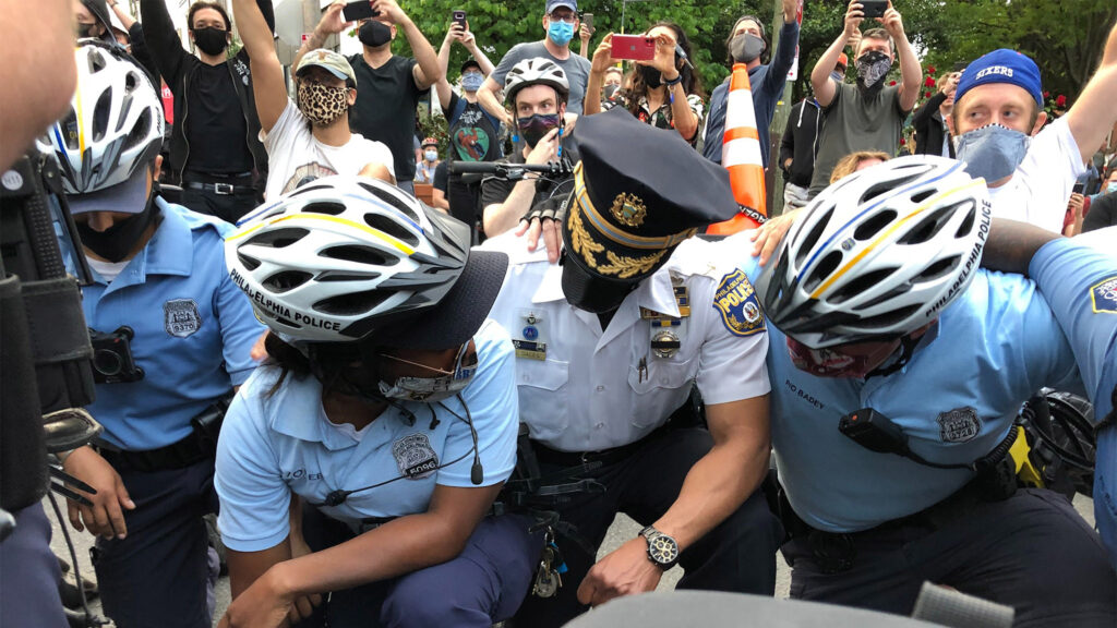 policekneeling-floydprotests-crop Officer Quishanna Lee, who has served on the force for three years, knelt with protesters Tuesday, and cried. (Layla A. Jones/Billy Penn)