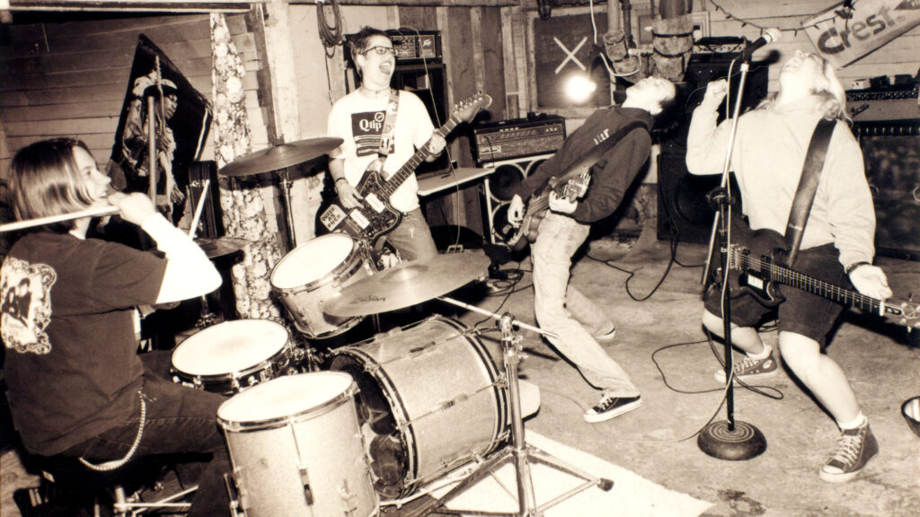 Team Dresch’s song “Fagetarian and Dyke” is featured in our playlist of queer punk.