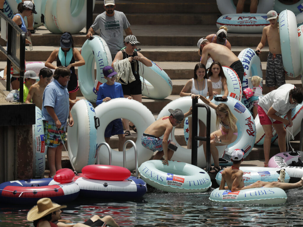 Tubers prepare to float the Comal River in New Braunfels, Texas, on Thursday, despite the recent spike in COVID-19 cases. Texas Gov. Greg Abbott said Wednesday that the state is facing a “massive outbreak” of the coronavirus and that some new local restrictions may be needed to preserve hospital space for new patients. Tubers prepare to float the Comal River in New Braunfels, Texas, on Thursday, despite the recent spike in COVID-19 cases. Texas Gov. Greg Abbott said Wednesday that the state is facing a